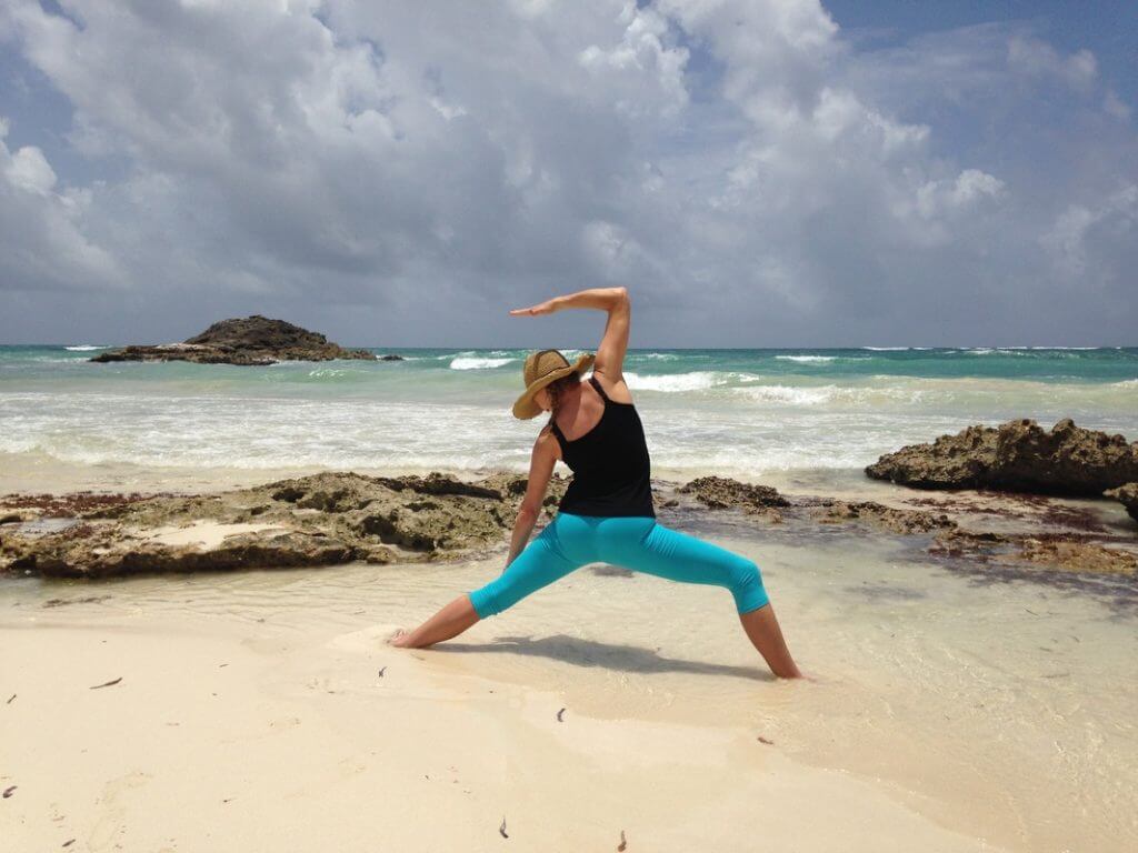 jenny rhodes yoga instructor doing yoga on beach